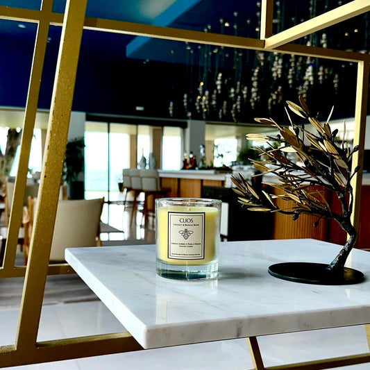 "Clios Golden Hour candle – luxury coconut and beeswax blend with vanilla embers, pear & freesia – displayed on marble shelf in a modern, upscale interior with gold accents – clean burn, hand-poured in Royal Leamington Spa."

